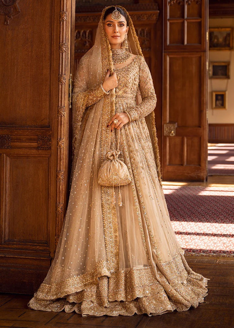 Woman in a traditional embroidered outfit standing in a room with wooden walls.