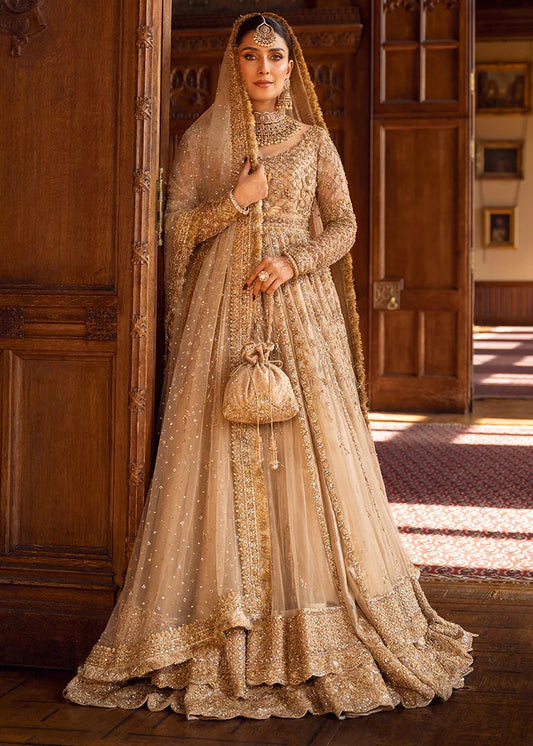Woman in a traditional embroidered outfit standing in a room with wooden walls.