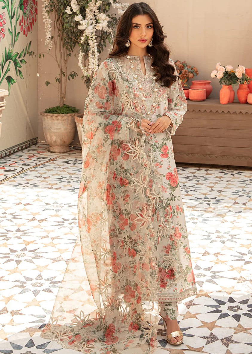 Woman in a floral dress standing in a decorated room with plants and flowers.