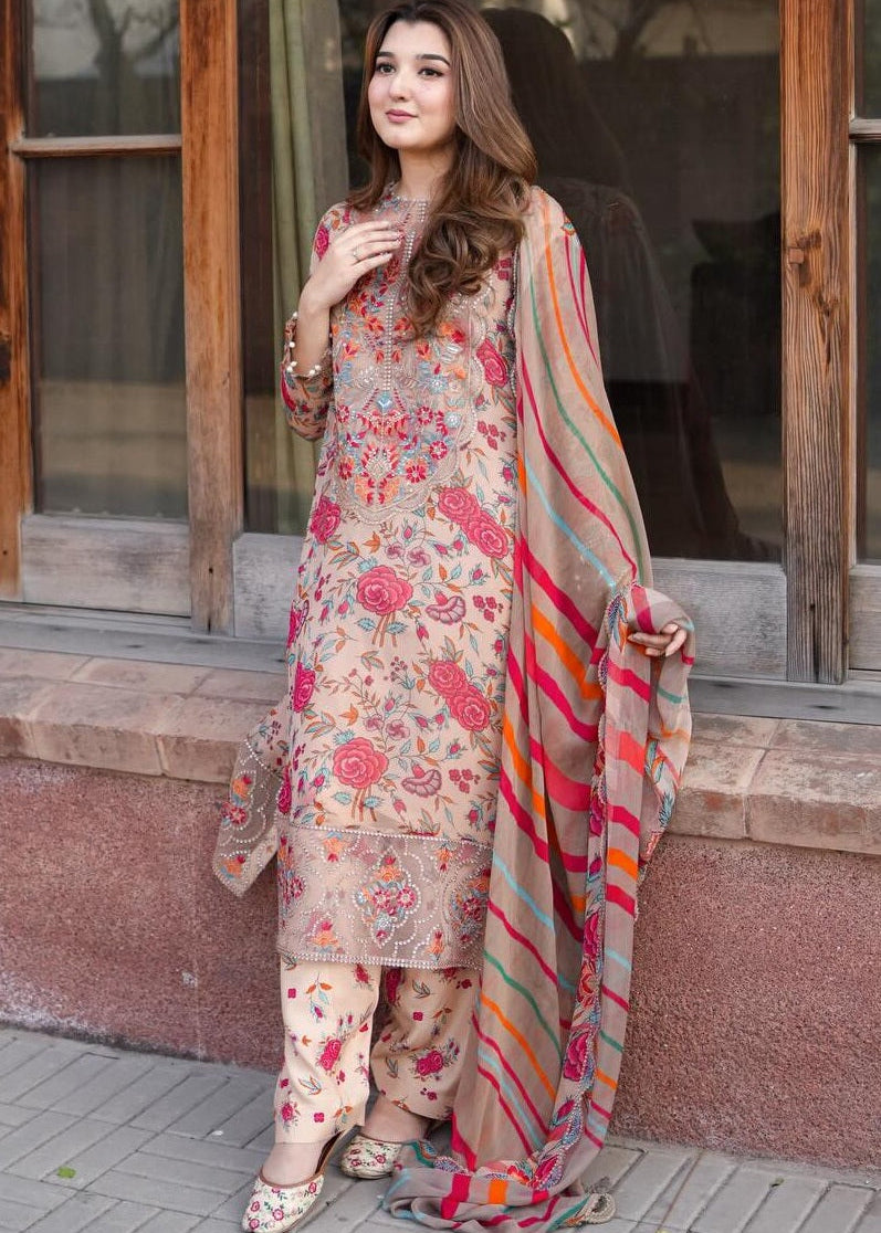 Woman in a floral dress with a colorful dupatta standing outside a building.