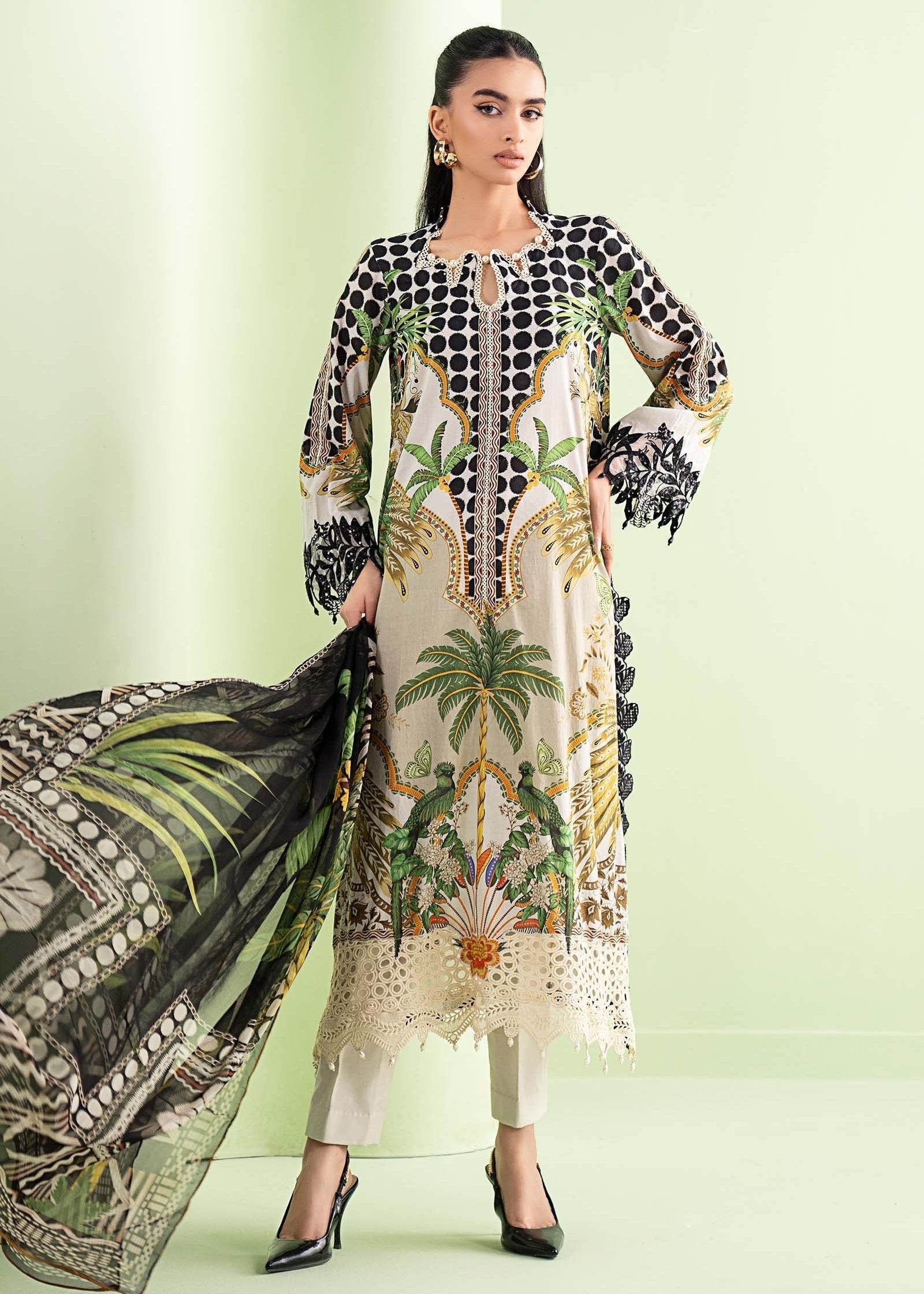 Woman wearing a patterned outfit with a green background