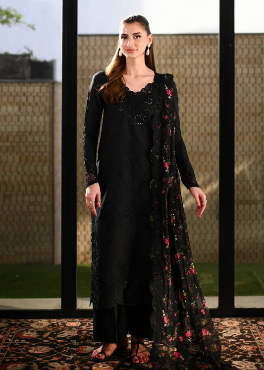 Woman wearing a black outfit with floral details in an outdoor setting