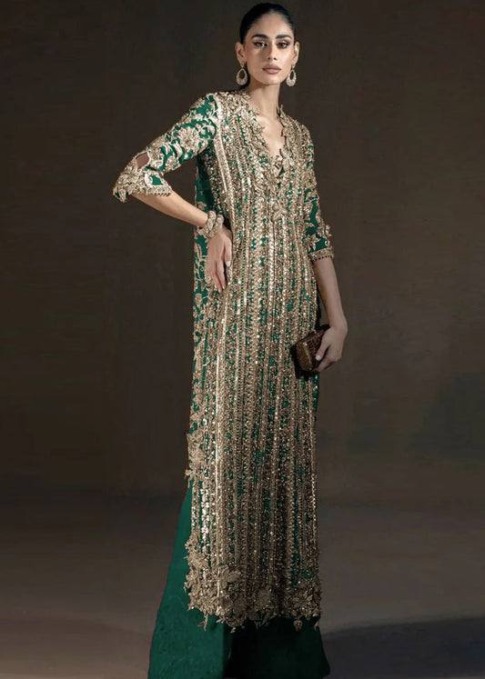 Woman wearing a long, patterned dress with a dark background