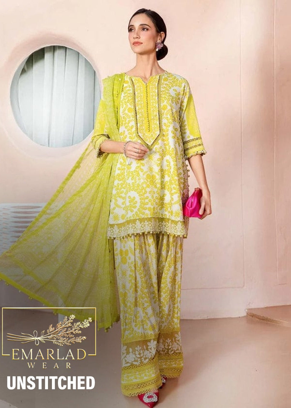 Woman wearing a yellow and white patterned un-stitched outfit with 'Emarlad Wear' branding.